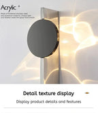 Modern wall light fixture with metallic finish on a textured wall background