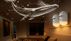 Whale design on ceiling with wall lights in a room